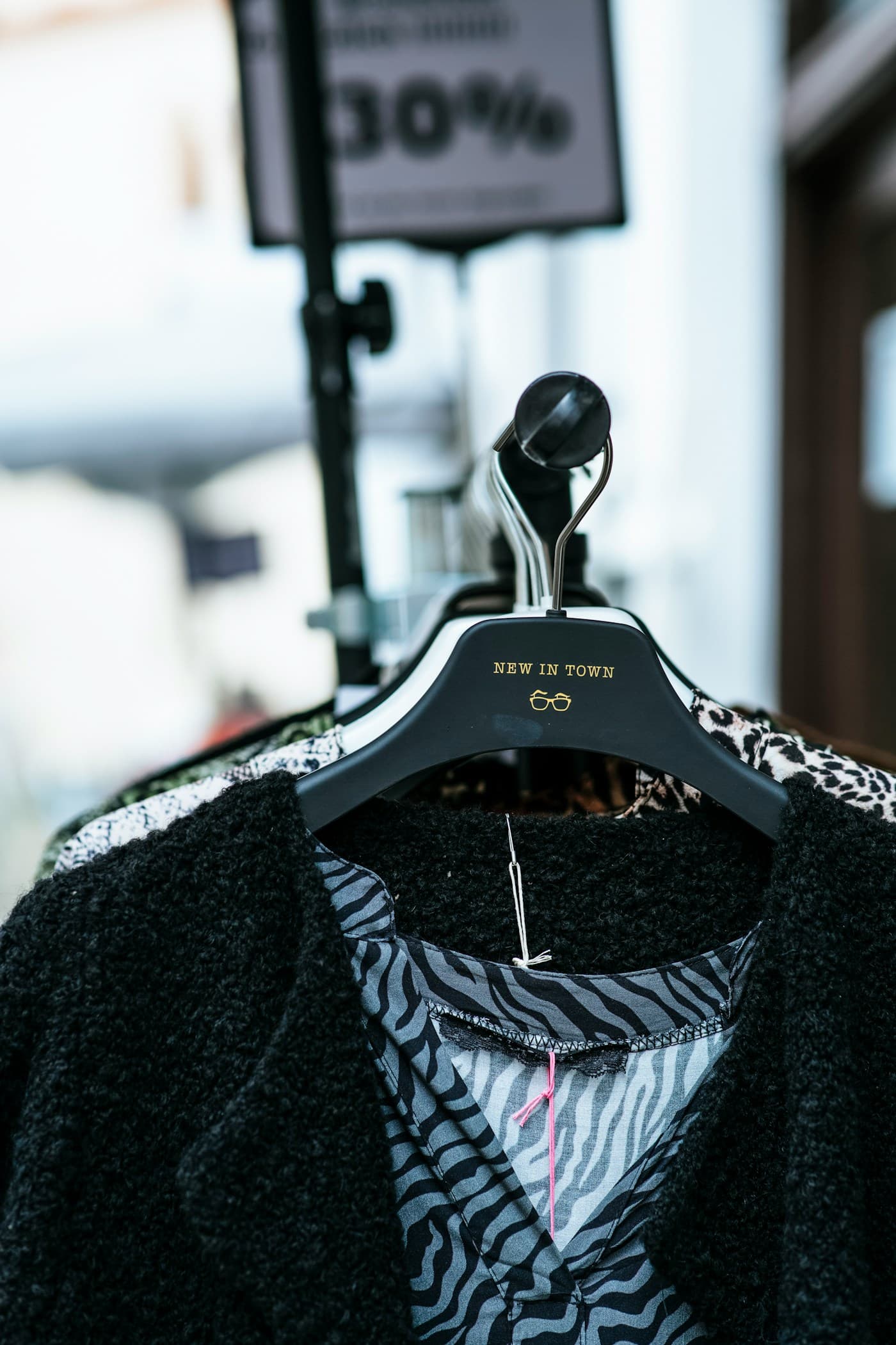 Black and white image of a garment suspended from a hanger.